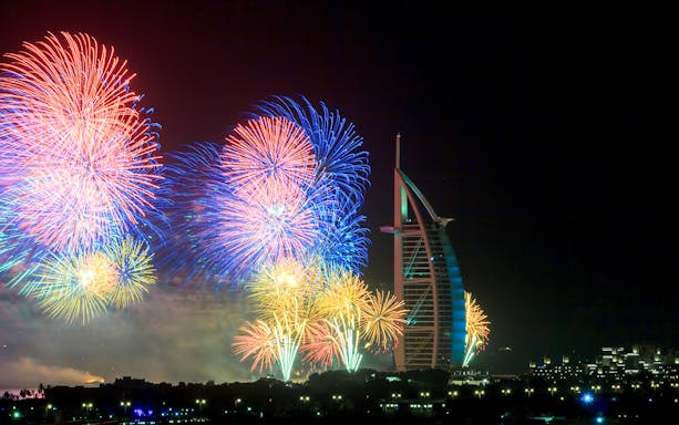 Fireworks display over Burj Al Arab during New Year Eve speedboat tour in Dubai.