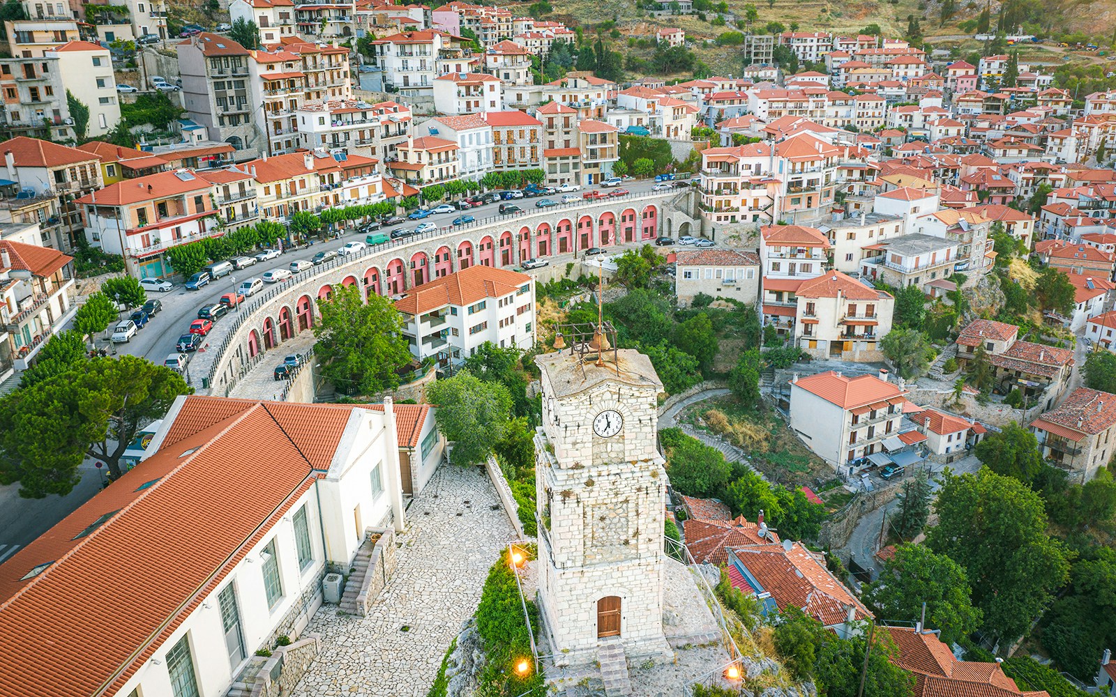 Aerial view of Arachova Village with clock tower and red-roofed houses in Greece.