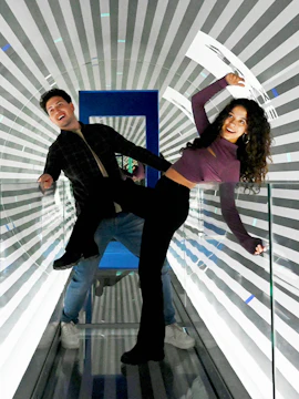 Visitors enjoying an optical illusion tunnel at Paradox Museum Barcelona.