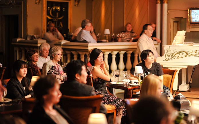 Audience enjoying a live performance at Gala Tango Show in Buenos Aires.
