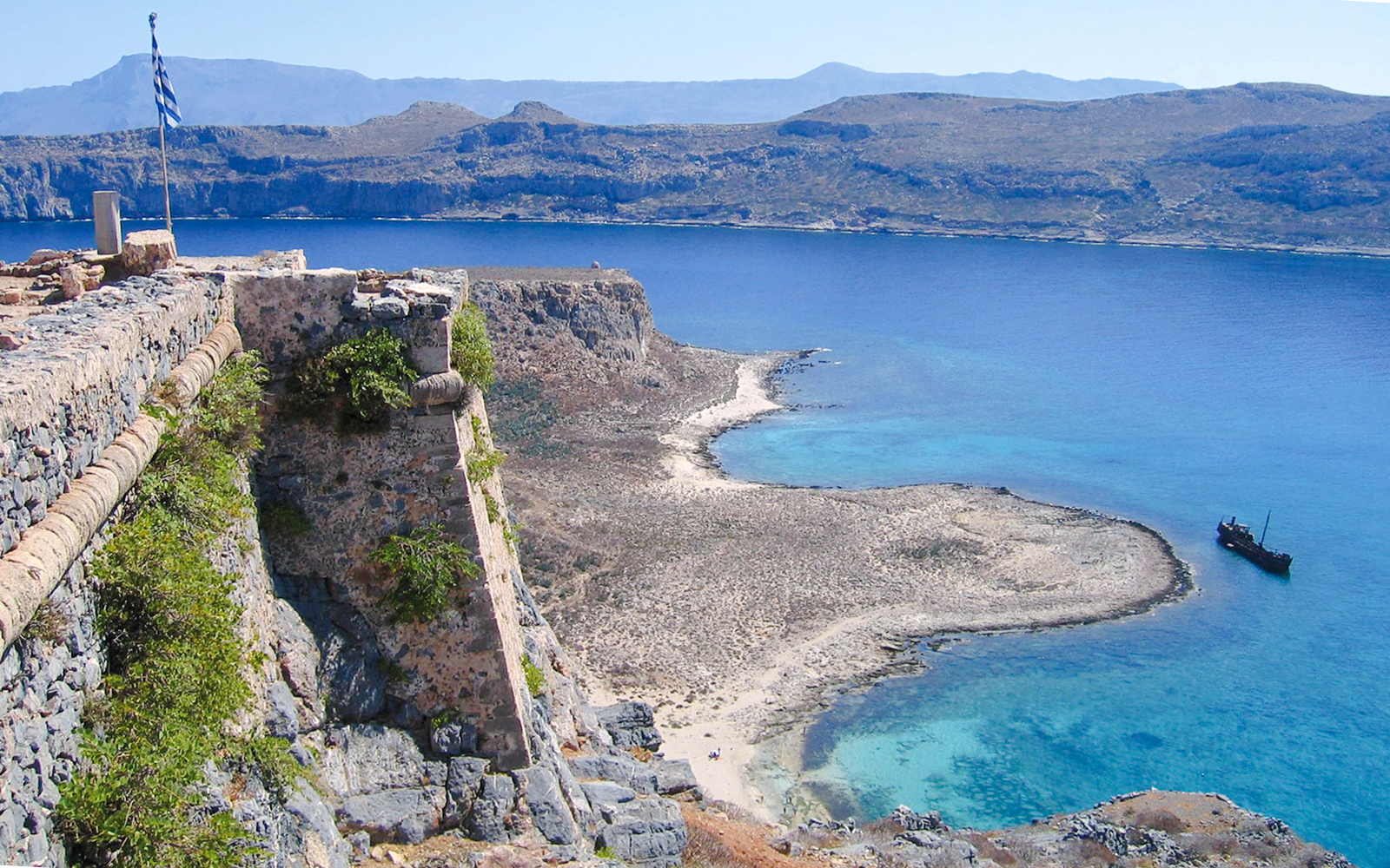 View from Venetian fortress on Gramvousa Island overlooking turquoise sea and rocky coastline.