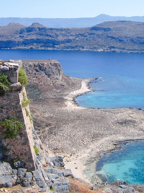 View from Venetian fortress on Gramvousa Island overlooking turquoise sea and rocky coastline.