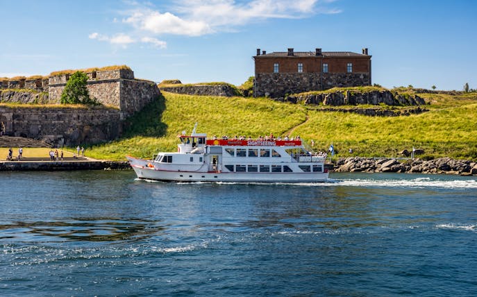 Sightseeing ferry near Suomenlinna Fortress, Helsinki, during evening tour.