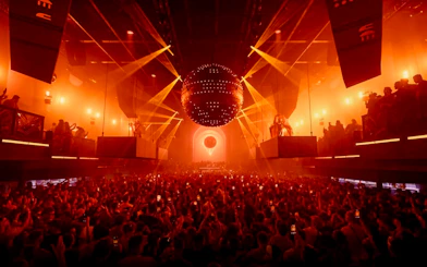 Crowd enjoying a vibrant light show at a nightclub in Ibiza.