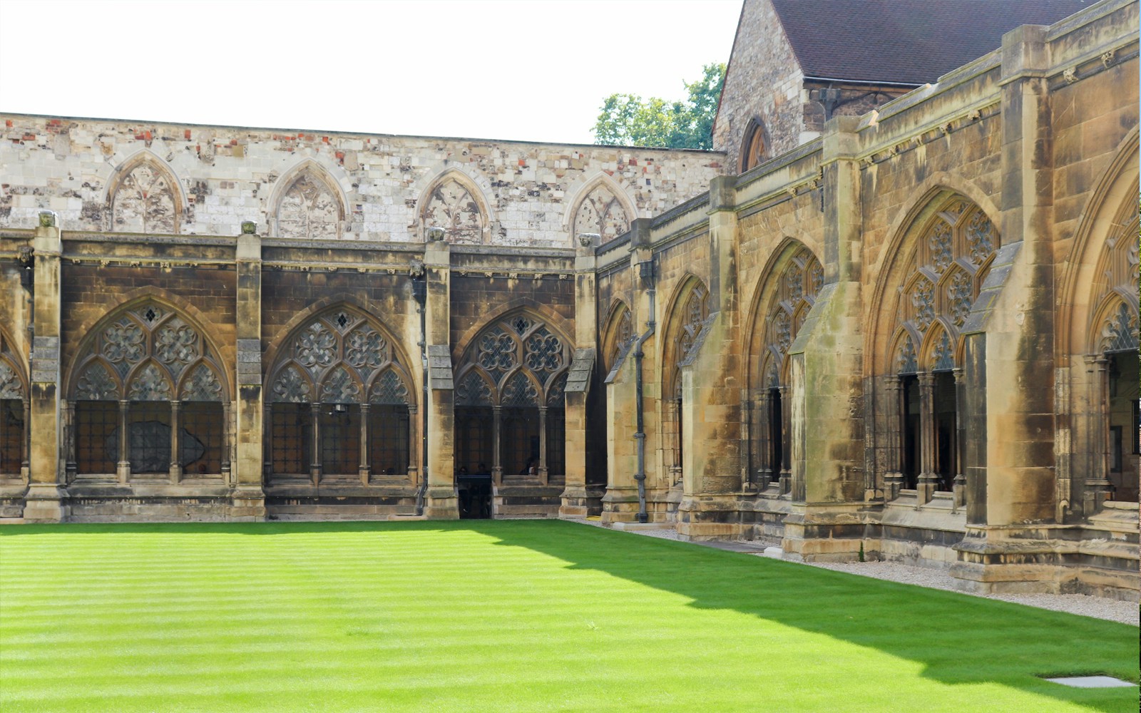 Cloister courtyard with arched stone windows at a historic cathedral.
