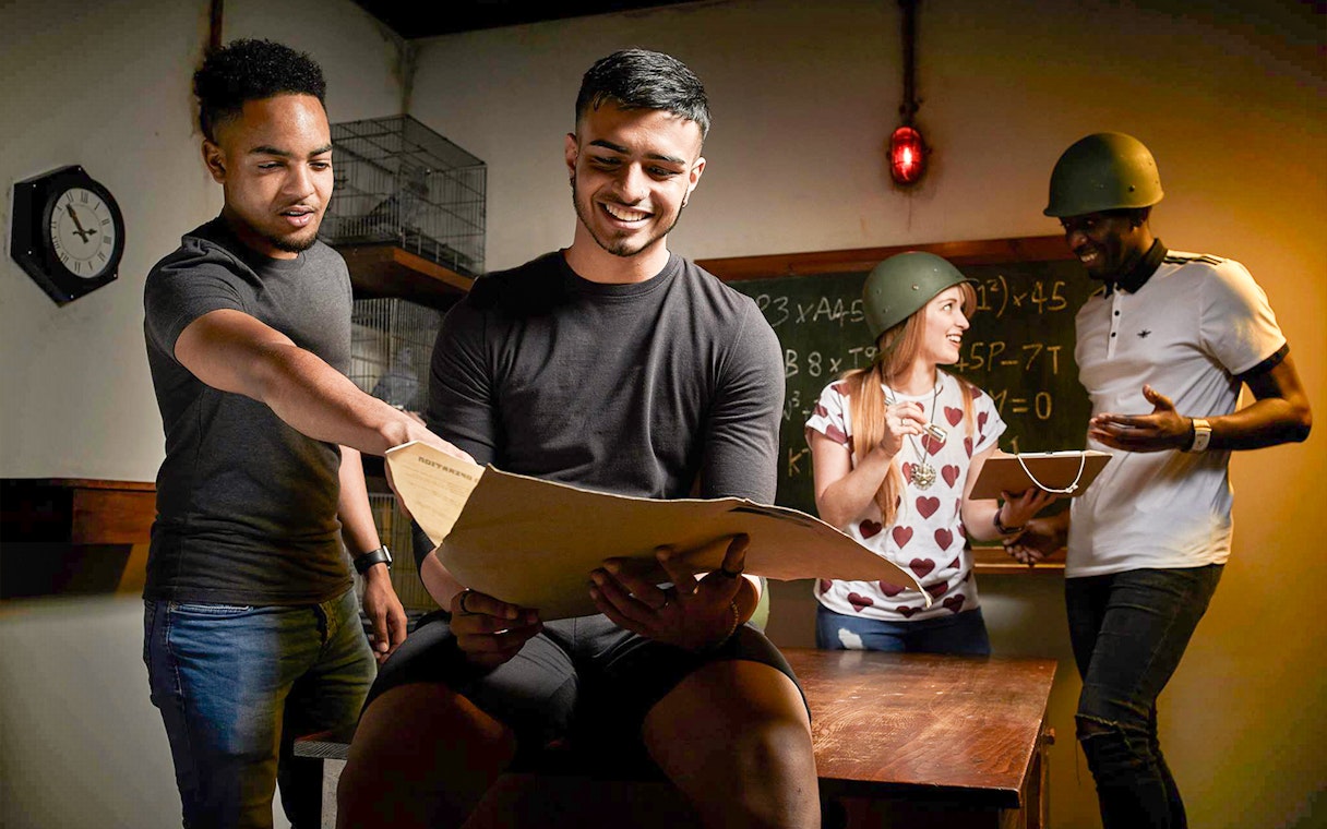 People solving puzzles in a Sydney escape room, part of the Sydney Explorer Pass by Go City.