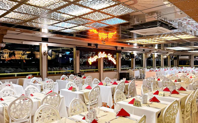 Elegant dining setup on a cruise ship with cityscape view at night, Istanbul dinner tour.