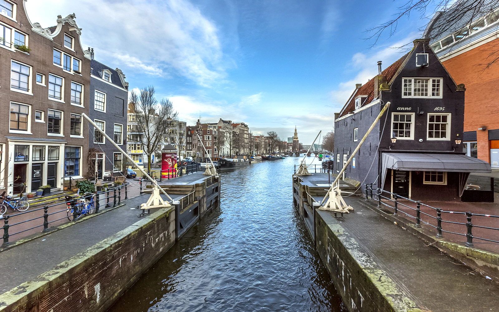 Amsterdam Sint Antoniesluis canal with historic buildings and boats in view.