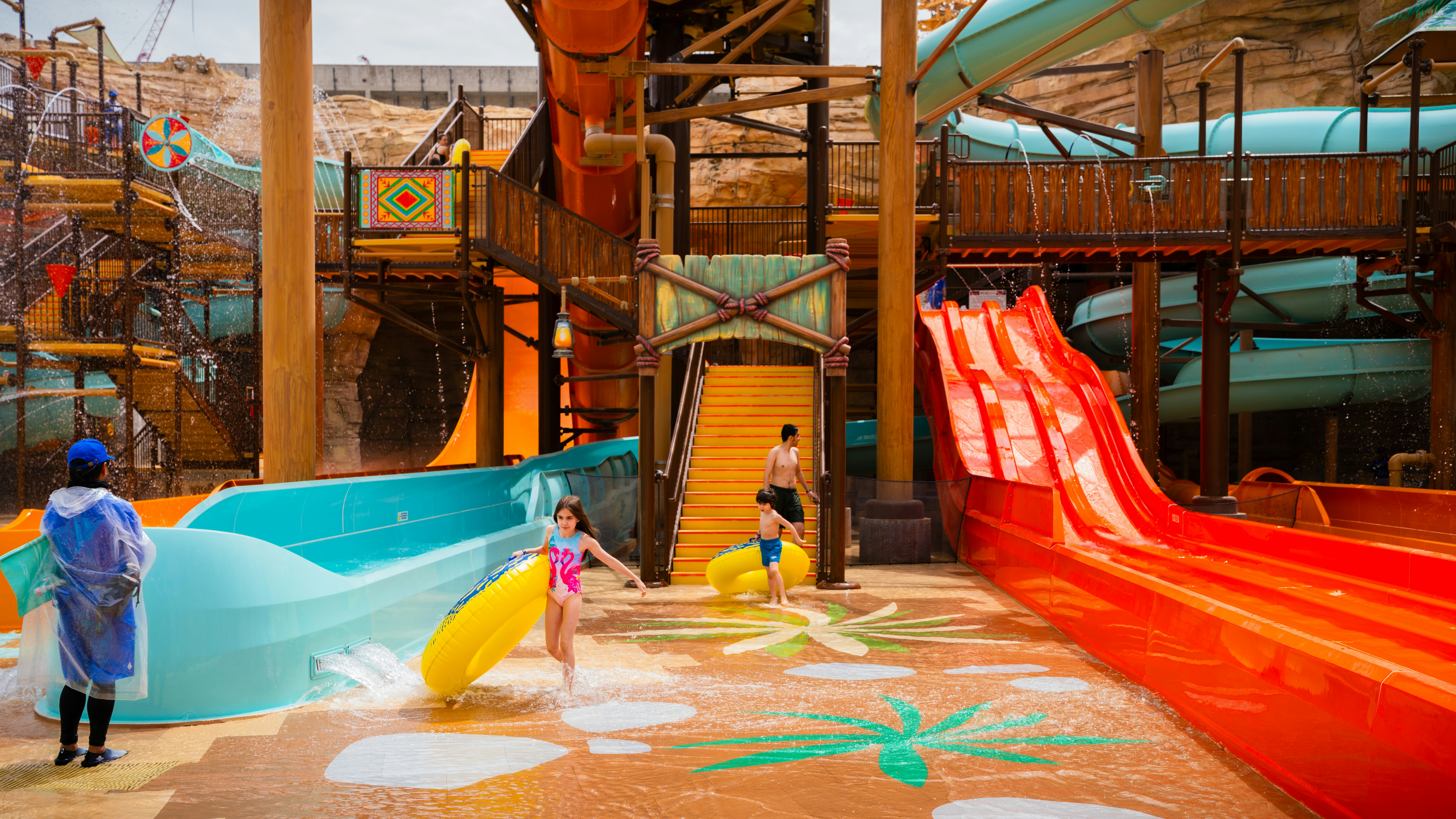 Kids playing with inflatable tubes at Aquarabia Water Theme Park, Qiddiya City, Saudi Arabia.