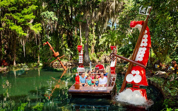 Pirate-themed boat ride through lush greenery at Pirate River Quest, Legoland Florida.