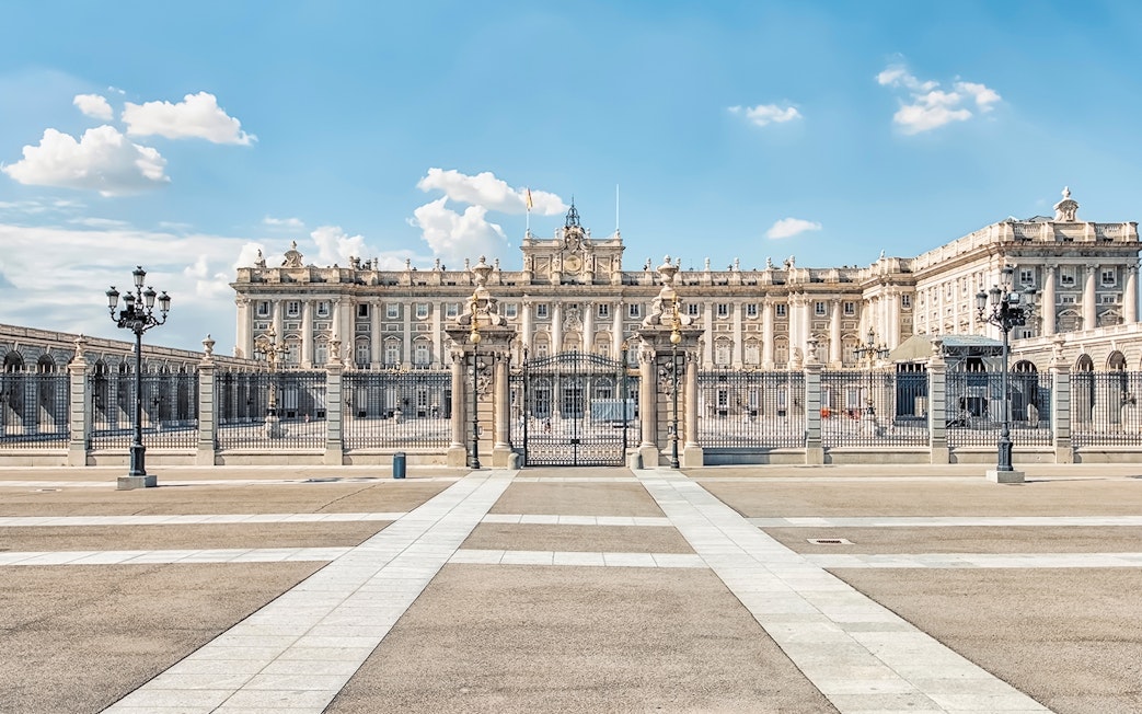 Royal Palace of Madrid exterior with ornate gates and courtyard.