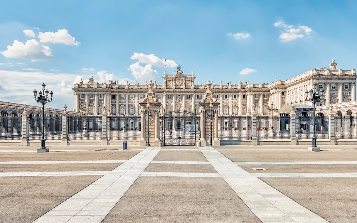 Royal Palace of Madrid exterior with ornate gates and courtyard.