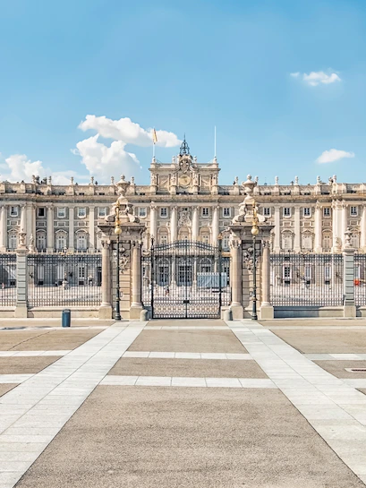 Royal Palace of Madrid exterior with ornate gates and courtyard.