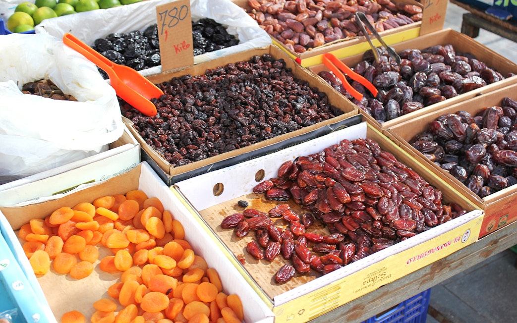 Dried fruits and dates displayed at a market in Abu Dhabi during a city tour from Dubai.
