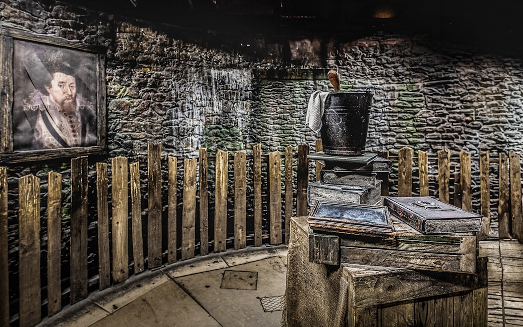 Edinburgh Dungeon Witches Judgement scene with wooden fence and historical props.