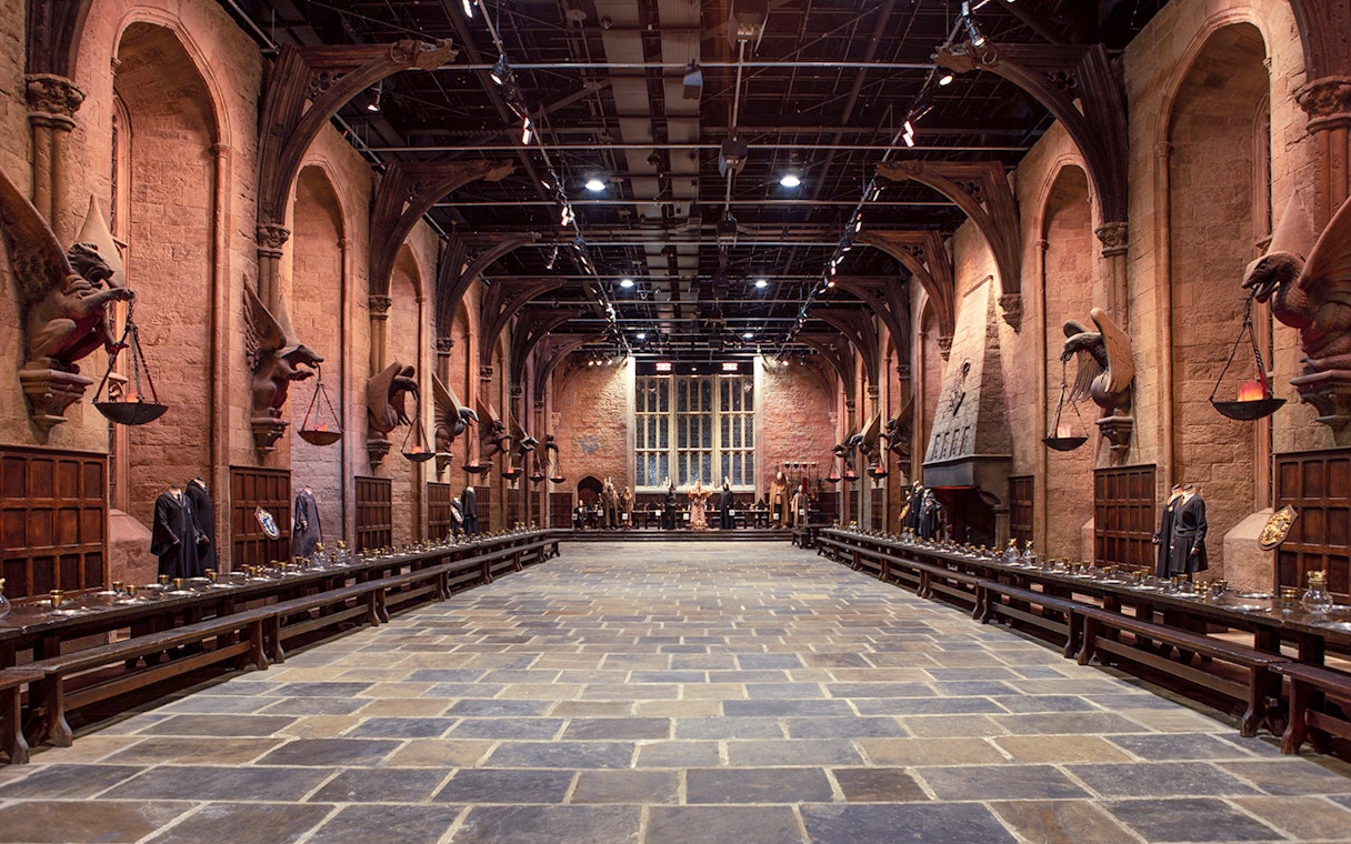Great Hall set at Warner Bros. The Making of Harry Potter Studio Tour, featuring long tables and stone arches.