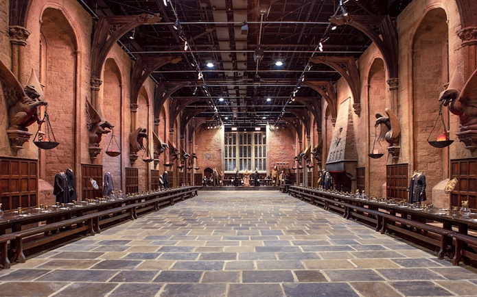 Great Hall set at Warner Bros. The Making of Harry Potter Studio Tour, featuring long tables and stone arches.