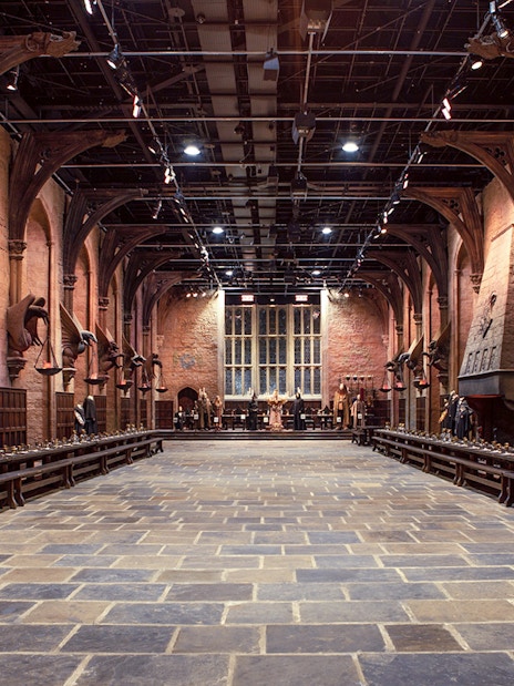 Great Hall set at Warner Bros. The Making of Harry Potter Studio Tour, featuring long tables and stone arches.