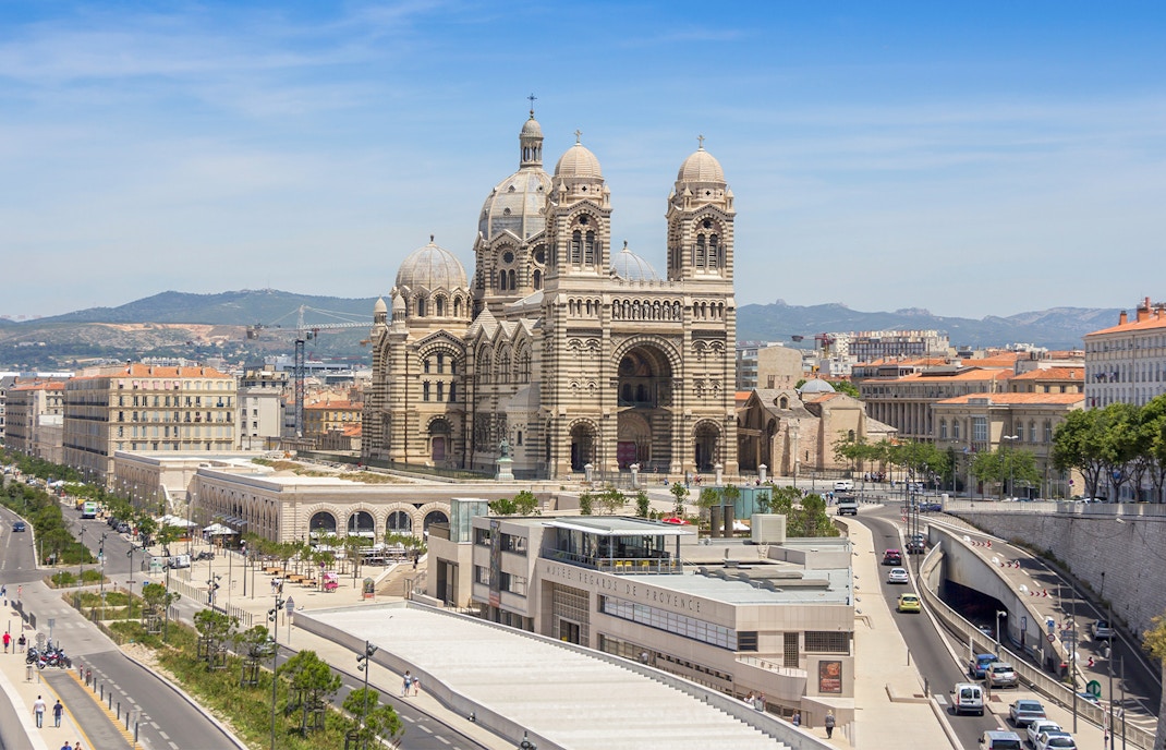 Cathedral de la Major in Marseille with hop-on hop-off tour bus in foreground.
