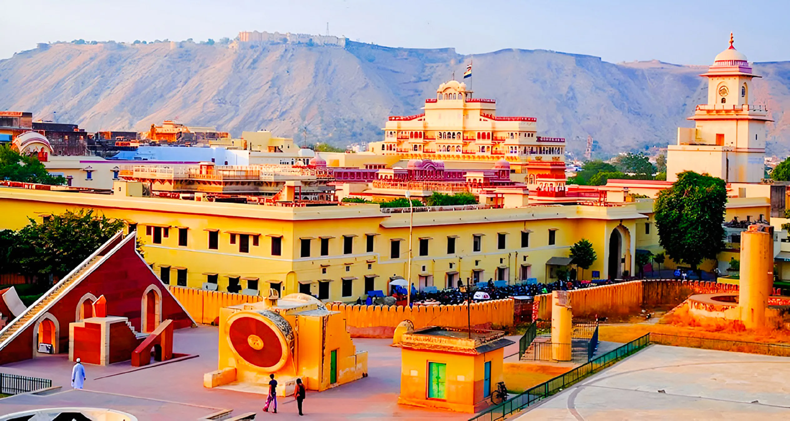Jaipur cityscape with Jantar Mantar observatory and historic architecture, viewed during a guided tour.