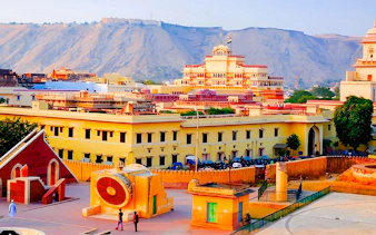 Jaipur cityscape with Jantar Mantar observatory and historic architecture, viewed during a guided tour.