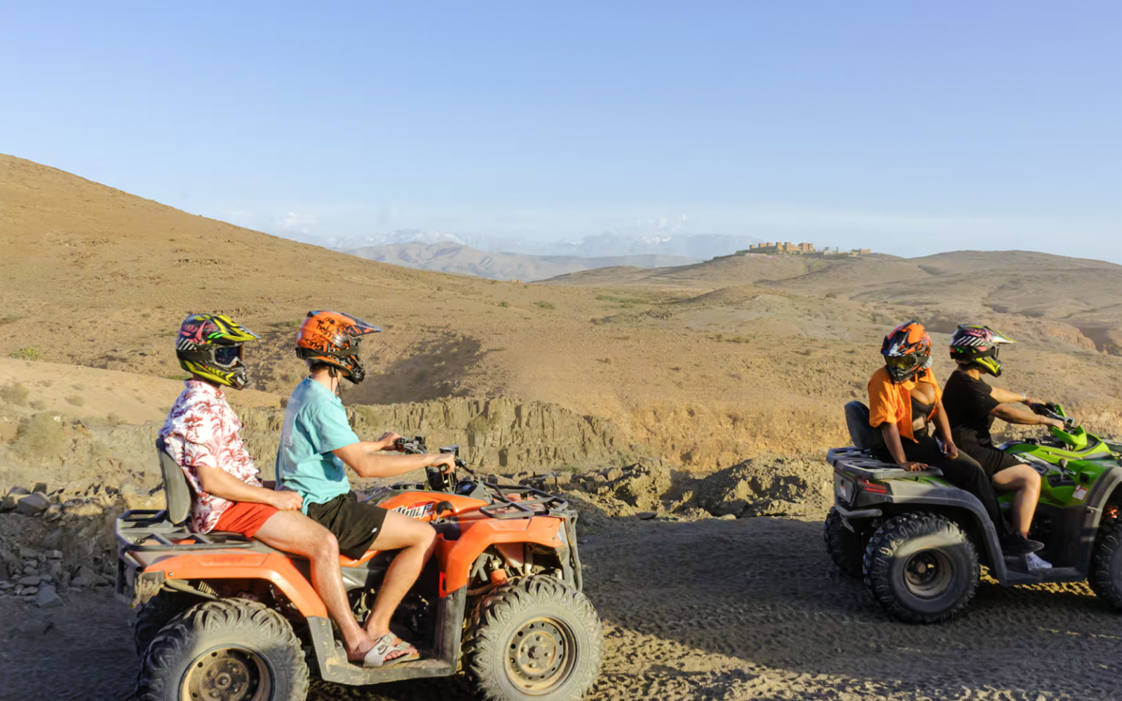 Quad biking in Agafay Desert, Marrakesh with distant hills in view.