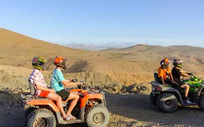 Quad biking in Agafay Desert, Marrakesh with distant hills in view.