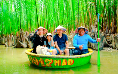 Group enjoying a basket boat ride through lush coconut groves in Da Nang, Vietnam.
