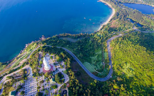 Panoramic view of coastline and lush greenery from Marble Mountains, Da Nang, Vietnam.