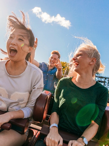 Young friends enjoying a roller coaster ride at Everland, South Korea.