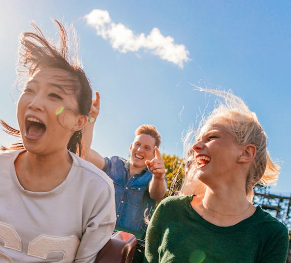 Young friends enjoying a roller coaster ride at Everland, South Korea.