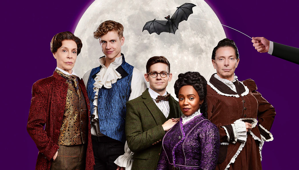 Cast of "Dracula, A Comedy of Terrors" in period costumes with a bat silhouette against a full moon.