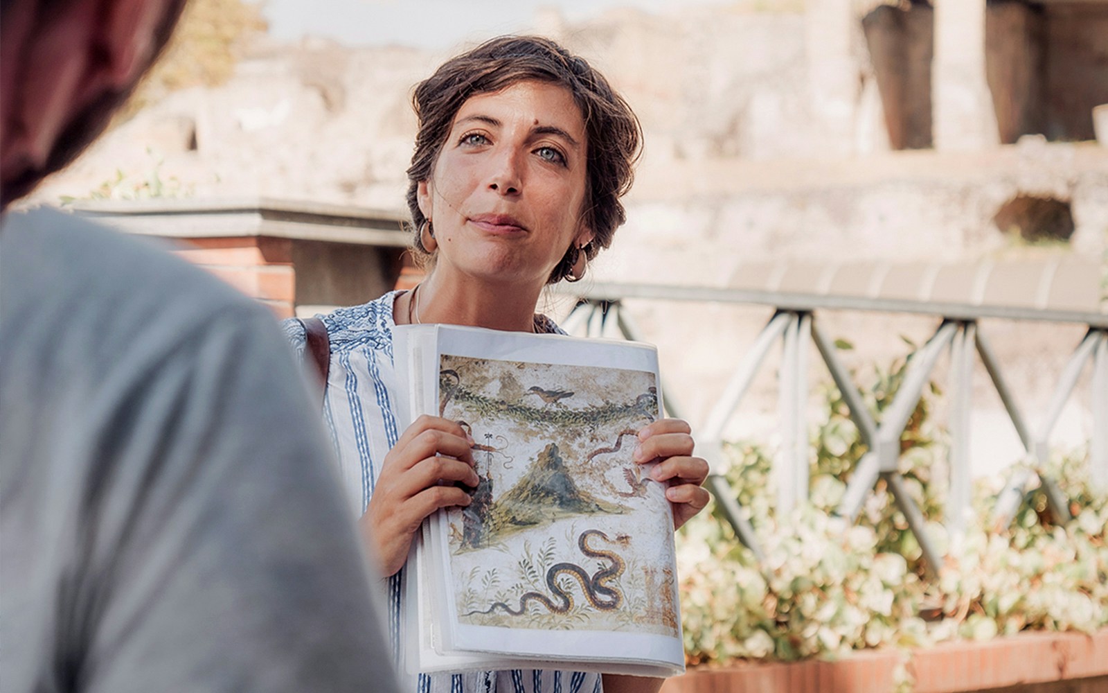 Small group of tourists enjoying a guided tour of Naples, Italy.