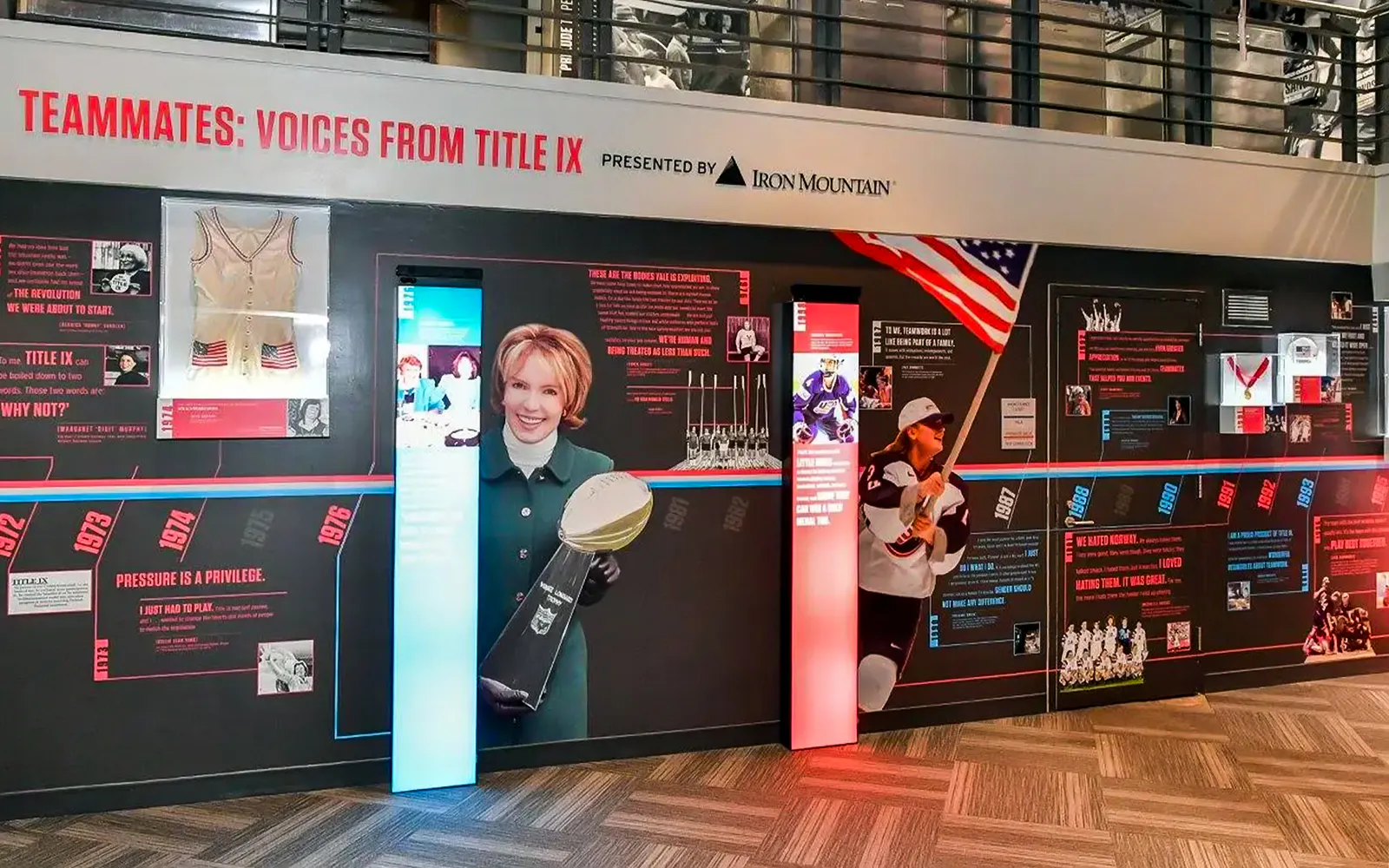 Exhibit on Title IX history at The Sports Museum, Boston featuring sports memorabilia and athletes.