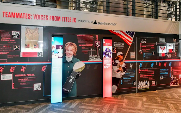 Exhibit on Title IX history at The Sports Museum, Boston featuring sports memorabilia and athletes.