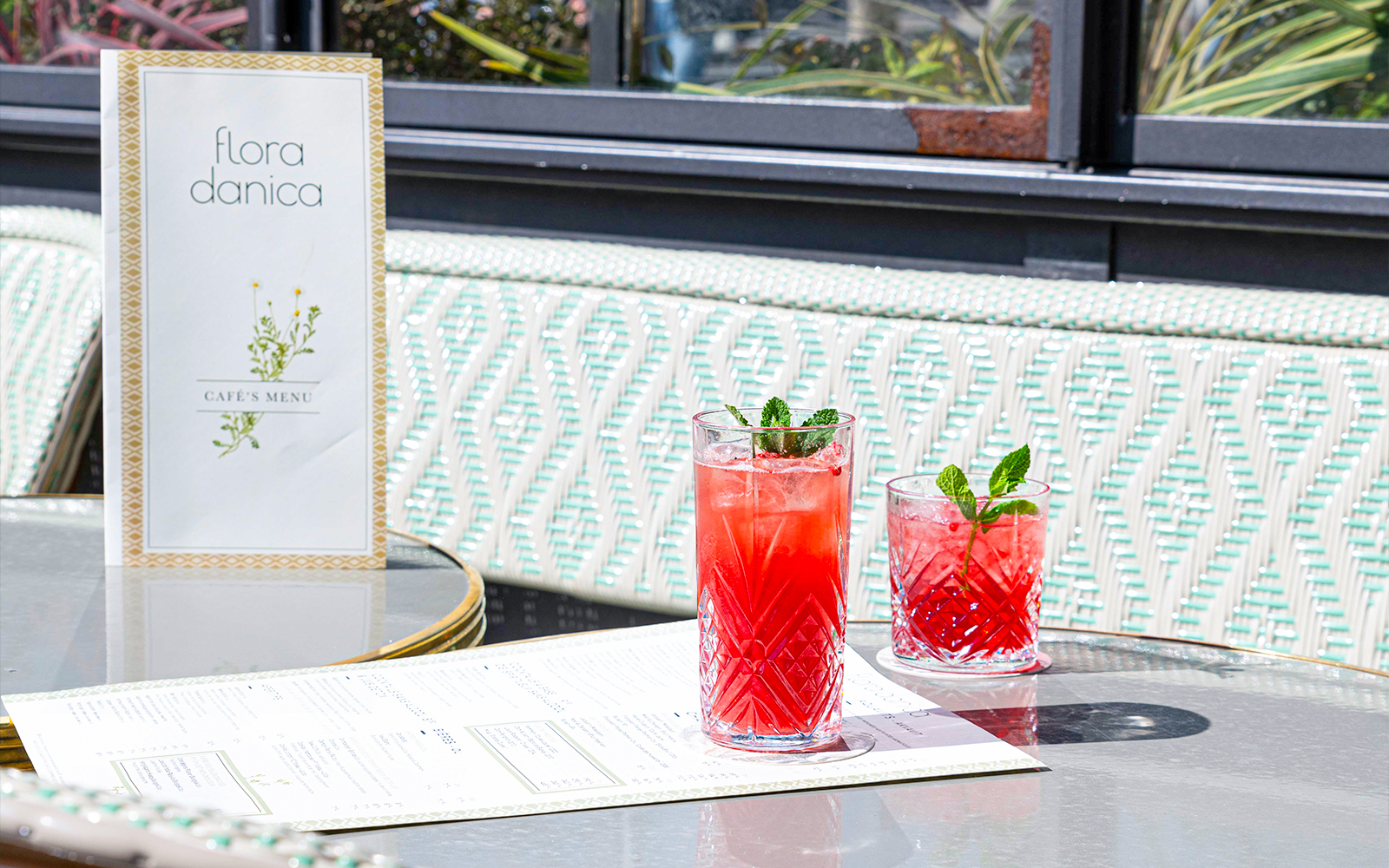 Flora Danica Paris menu and aperitif drinks on a table at Champs Elysées diner.