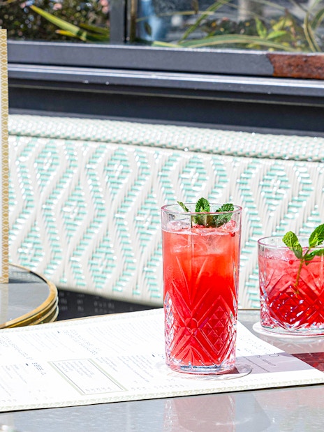Flora Danica Paris menu and aperitif drinks on a table at Champs Elysées diner.