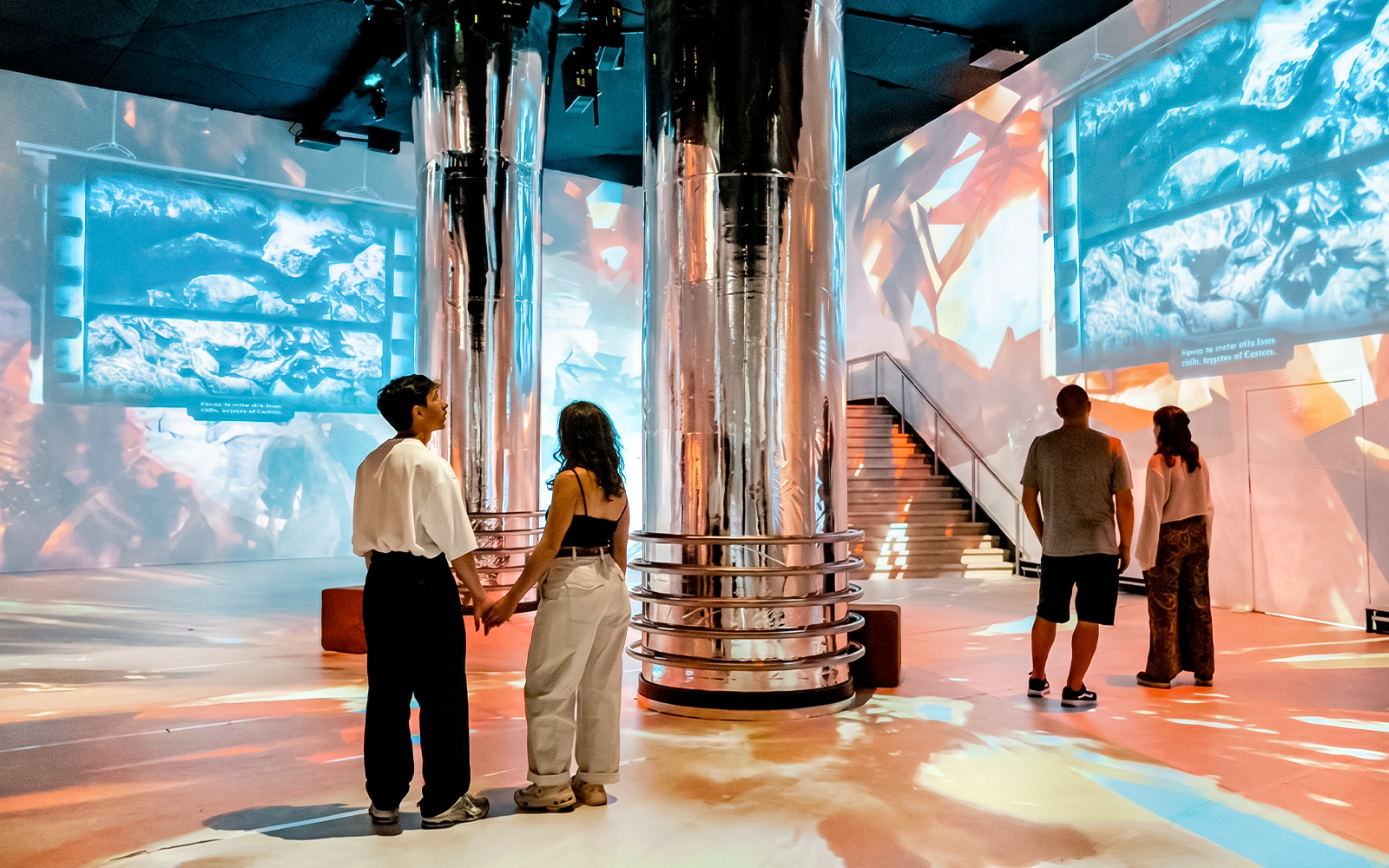 Immersive Jules Verne 200 exhibit with visitors viewing digital oceanic projections.