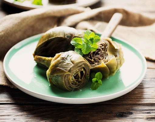 Carciofi alla Romana dish served on a white plate, showcasing Roman-style artichokes.