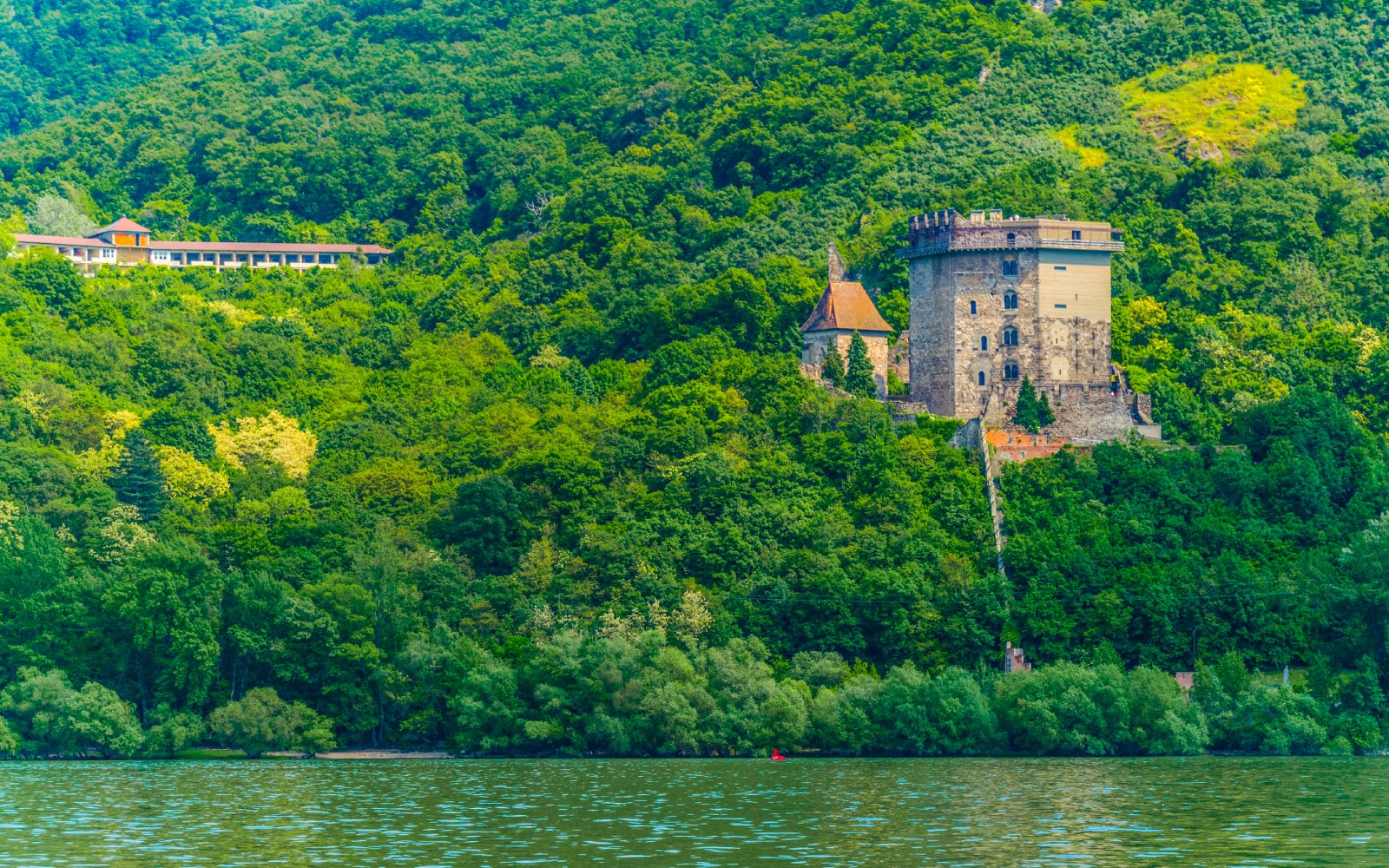 Solomon Tower beneath Visegrád Castle in Hungary surrounded by lush greenery.