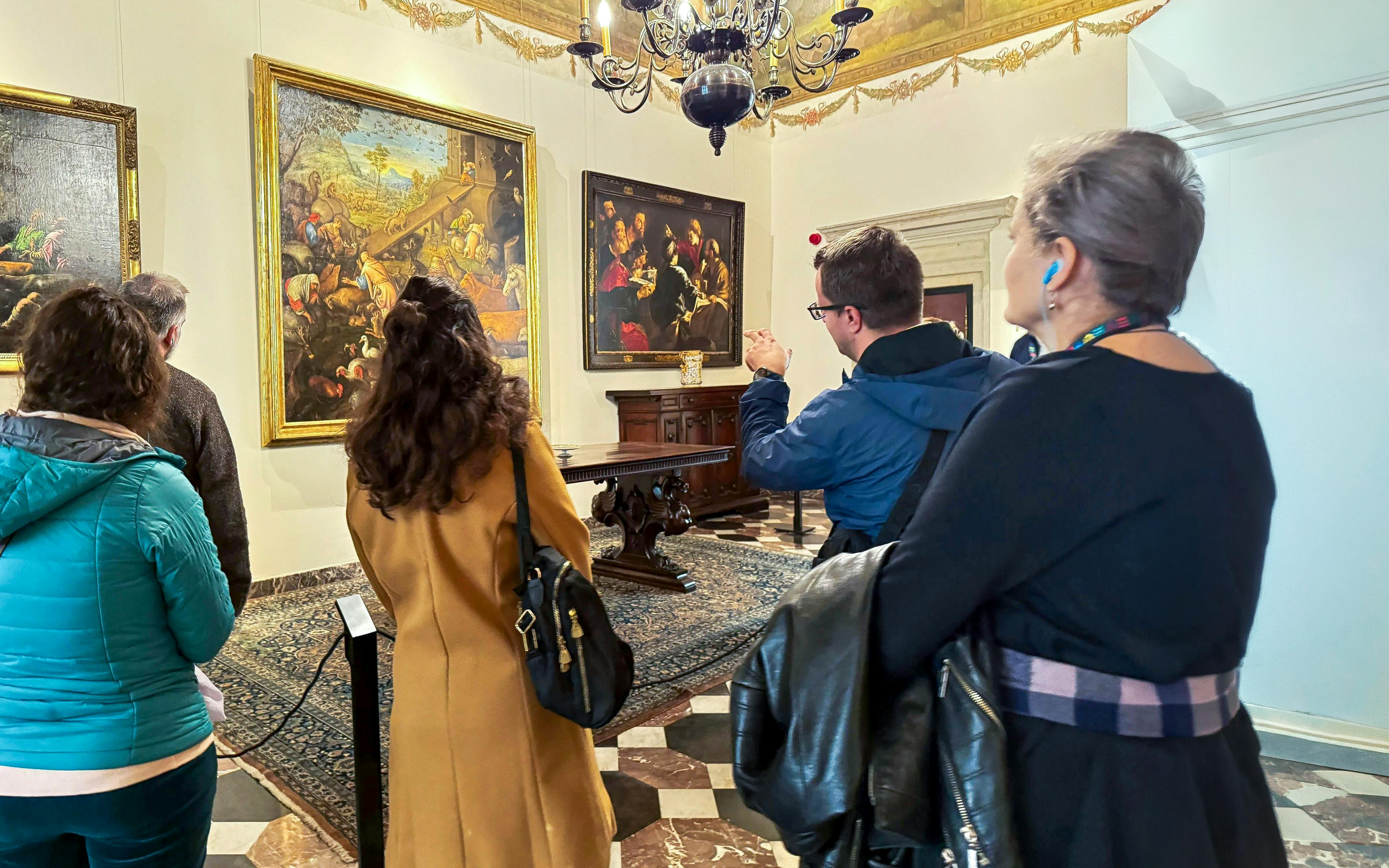 Guide explaining paintings to visitors inside Wawel Castle, Krakow, Poland.