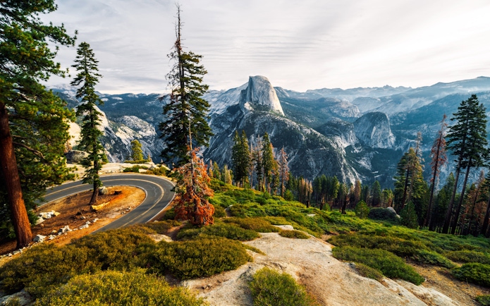 Winding road with view of Half Dome from Glacier Point, Yosemite National Park.