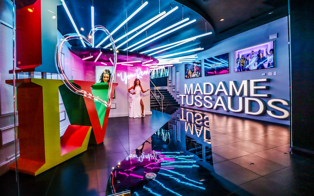 Madame Tussauds Las Vegas entrance with neon lights and wax figure display.