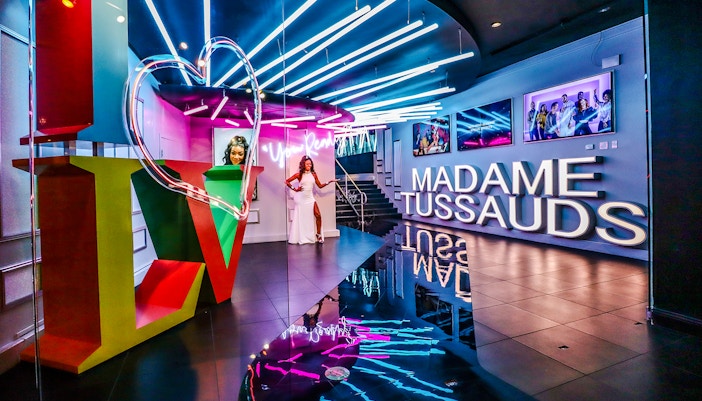 Madame Tussauds Las Vegas entrance with neon lights and wax figure display.