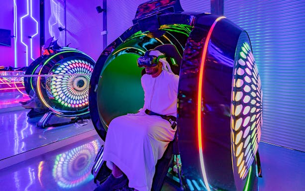 VR gaming experience at Pixoul Gaming, Abu Dhabi, with colorful lights and immersive setup.