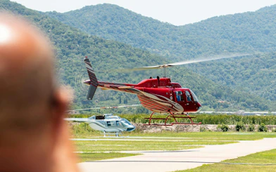Helicopter taking off for tour in Rio de Janeiro with mountains in background.