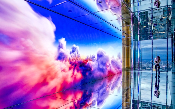 Colorful digital clouds display at SUMMIT One Vanderbilt observation deck.