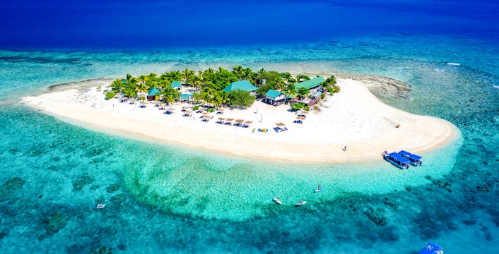Panoramic aerial view of South Sea Island, Fiji, with clear turquoise waters and sandy beaches.