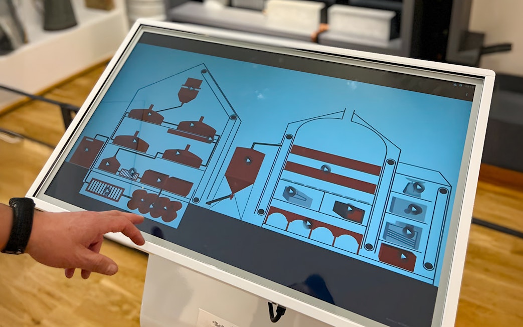 Interactive display showing beer brewing process at Prague Beer Museum.