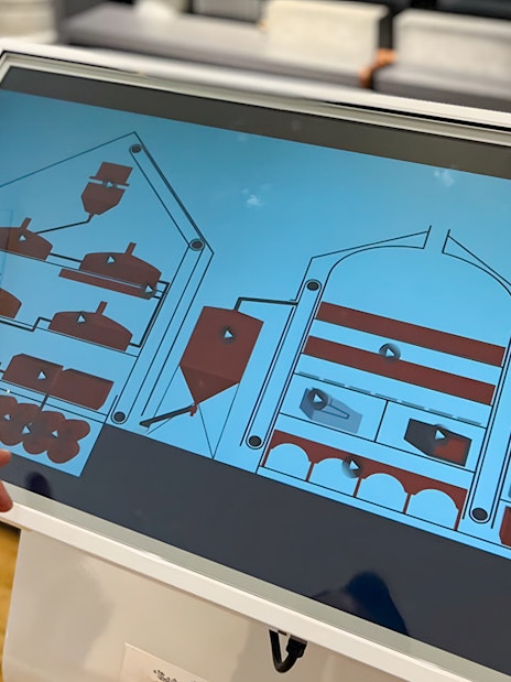 Interactive display showing beer brewing process at Prague Beer Museum.